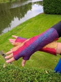 Bright and warm hand-made mittens are felted from soft merino wool.